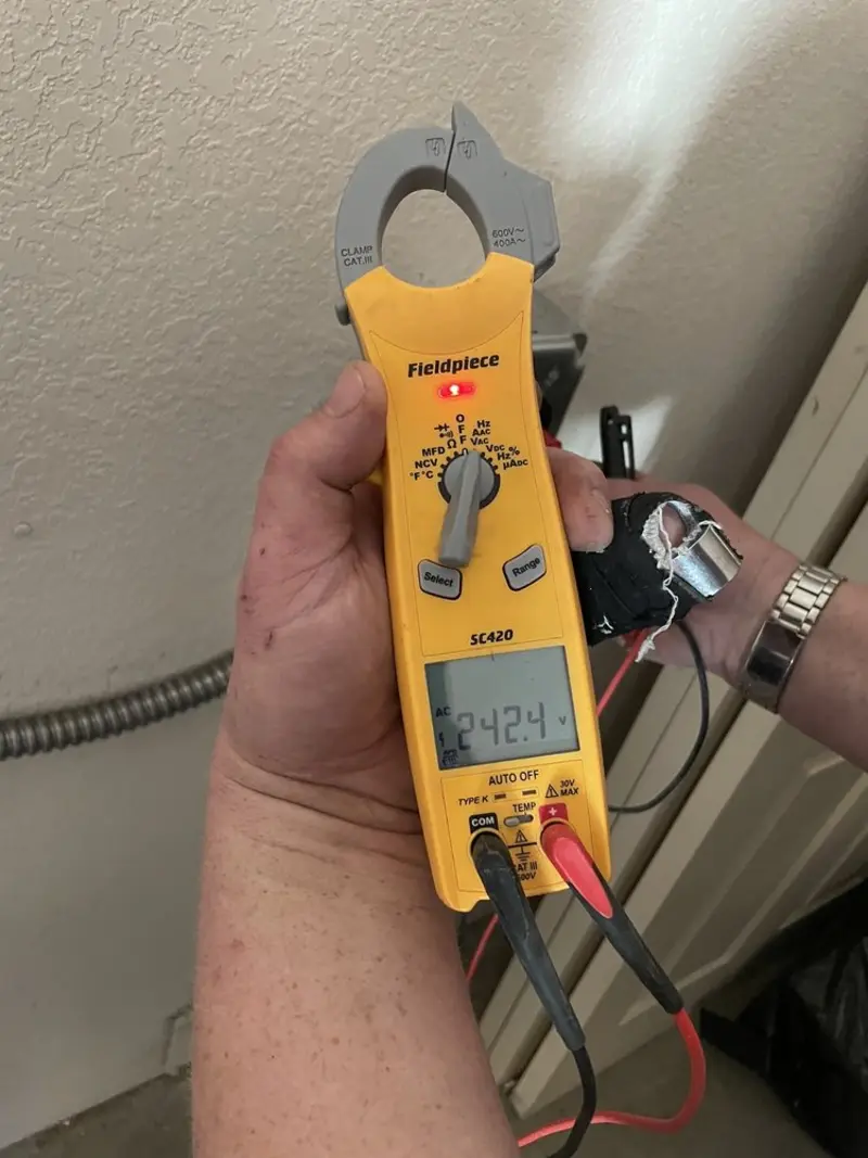 Voltage testing with clamp meter during Whole House Surge Protector in Camilla